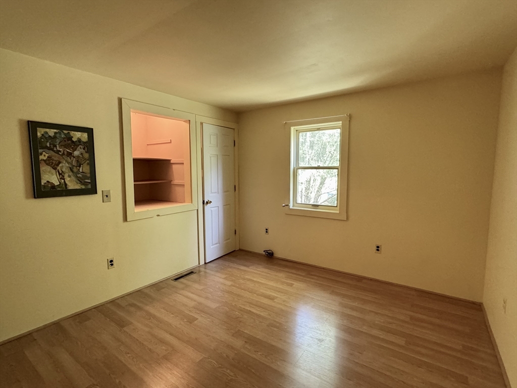 1450 W Road Ashfield, MA 01330 - Photo 22 of 36 a view of an empty room with wooden floor and a window