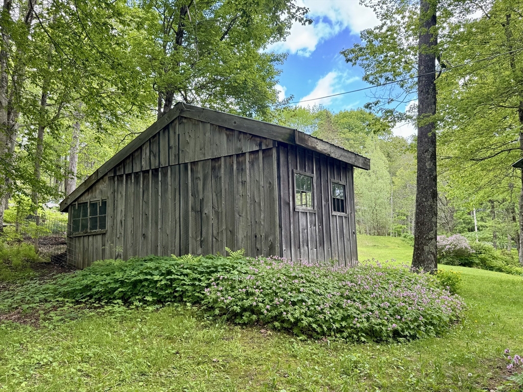 1450 W Road Ashfield, MA 01330 - Photo 32 of 36 a backyard of a house with lots of green space