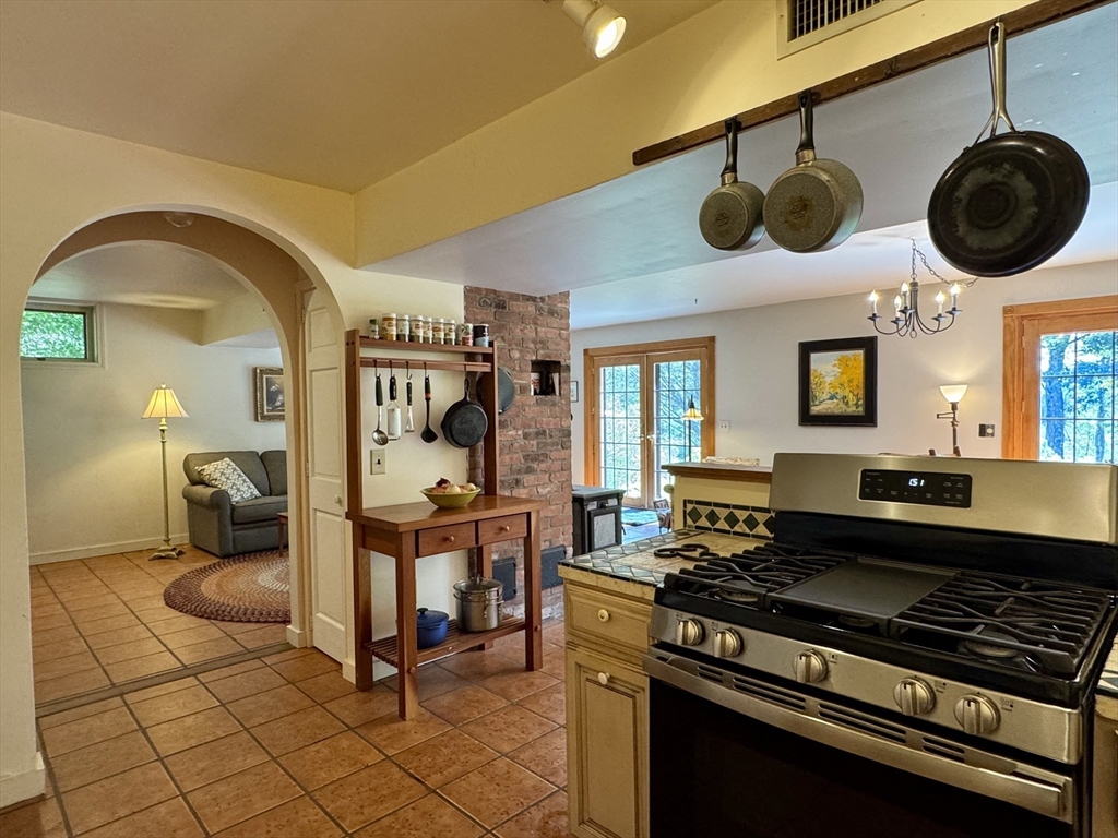 1450 W Road Ashfield, MA 01330 - Photo 6 of 36 a kitchen with a stove and a wooden floor