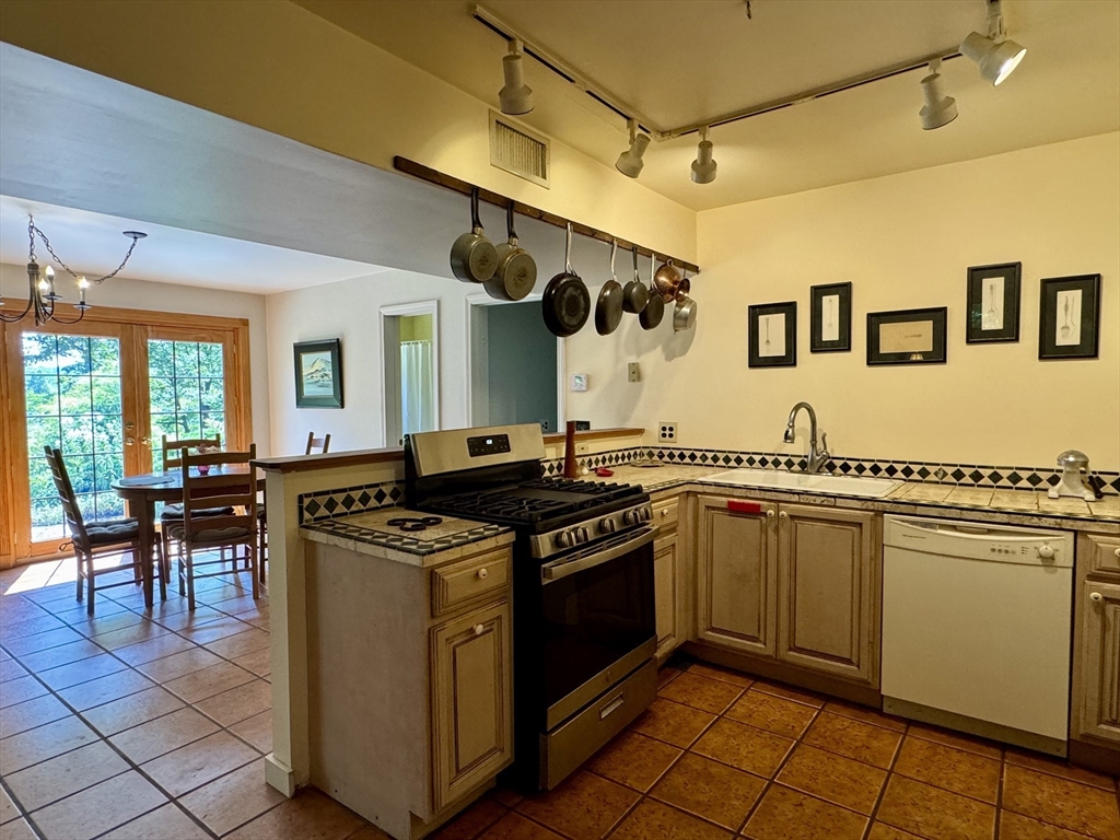 1450 W Road Ashfield, MA 01330 - Photo 8 of 36 a kitchen with stainless steel appliances granite countertop a stove and a sink