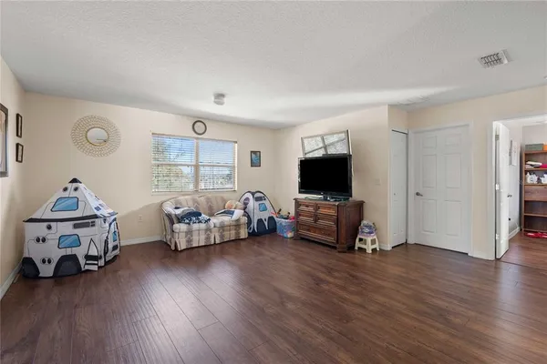 a view of a livingroom with furniture and a flat screen tv