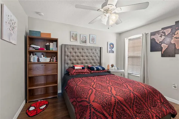 a bedroom with a bed and a chandelier
