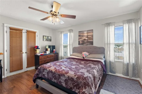 a bedroom with a large bed and a chandelier