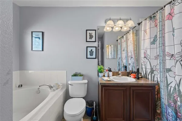 a white bath tub sitting next to a toilet