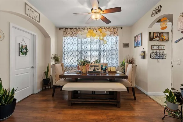 a view of a dining room with furniture and a potted plant