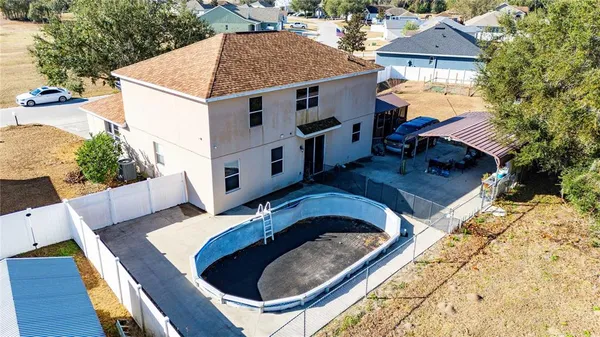 an aerial view of a house with a yard