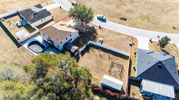 an aerial view of residential houses with outdoor space