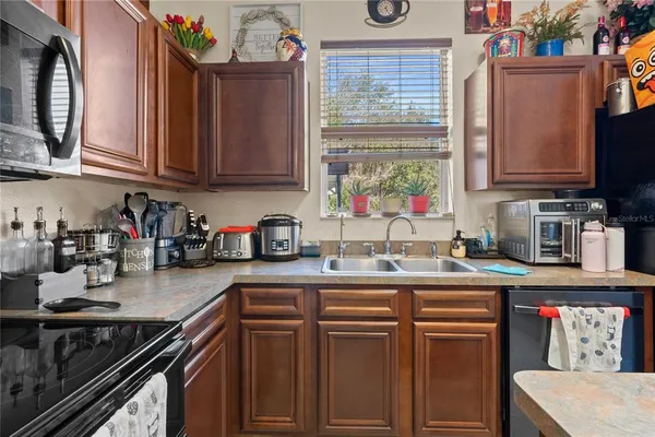 a kitchen with sink cabinets and stove