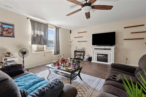 a living room with furniture a fireplace and a flat screen tv