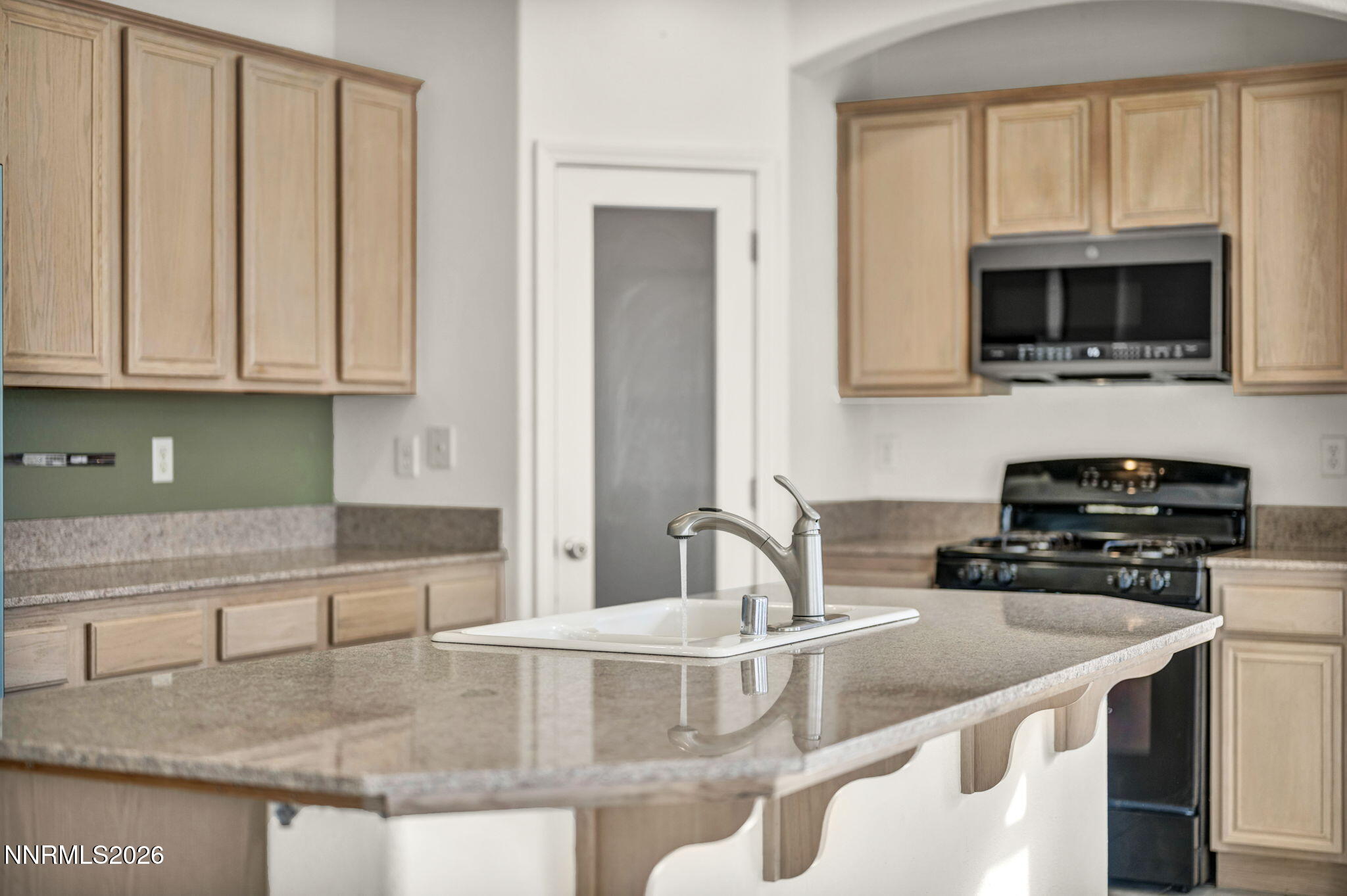 1472 Gaucho Lane Reno, NV 89521 - Photo 13 of 38 a kitchen with stainless steel appliances granite countertop a sink and a microwave