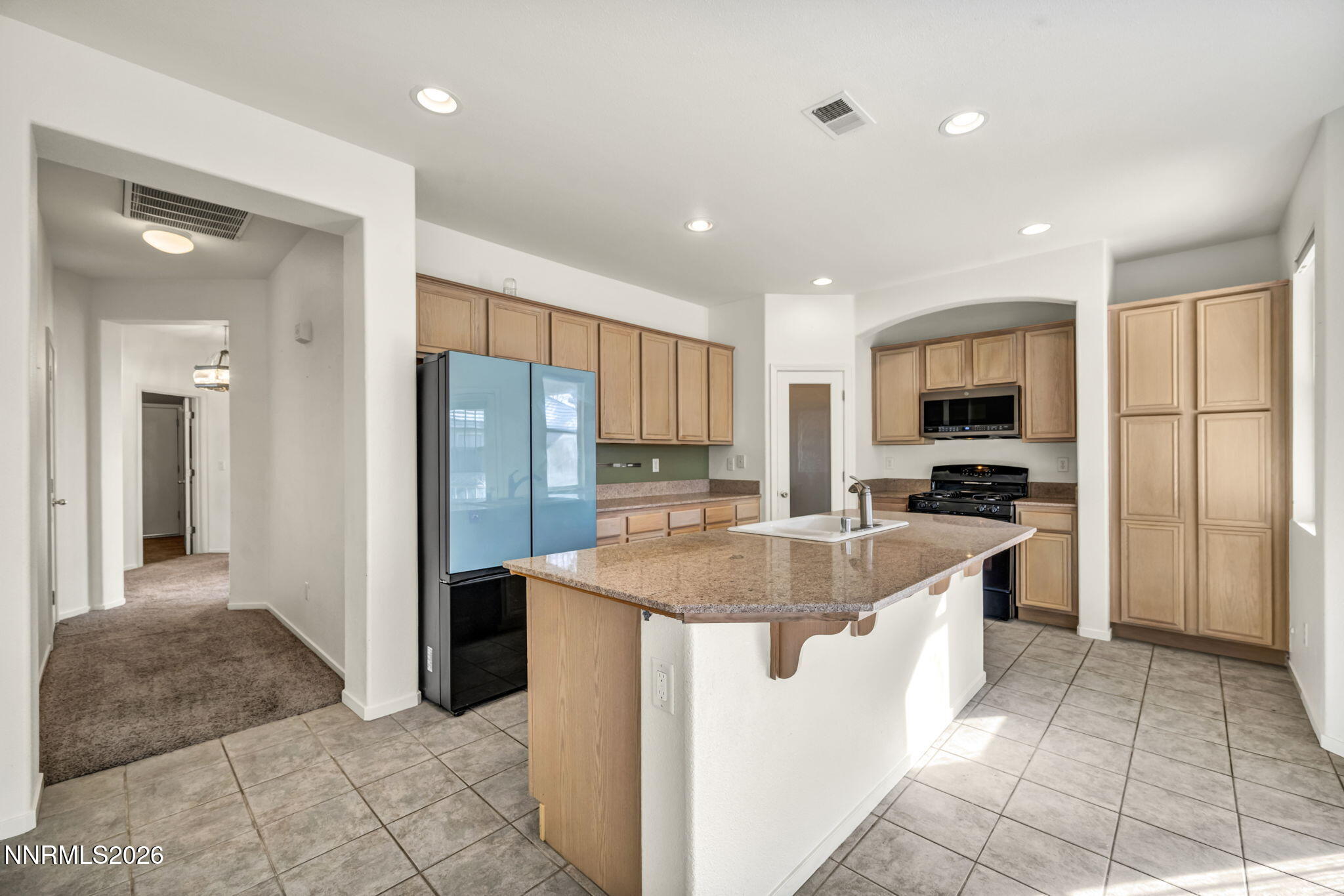 1472 Gaucho Lane Reno, NV 89521 - Photo 15 of 38 a kitchen with stainless steel appliances granite countertop a refrigerator sink and cabinets