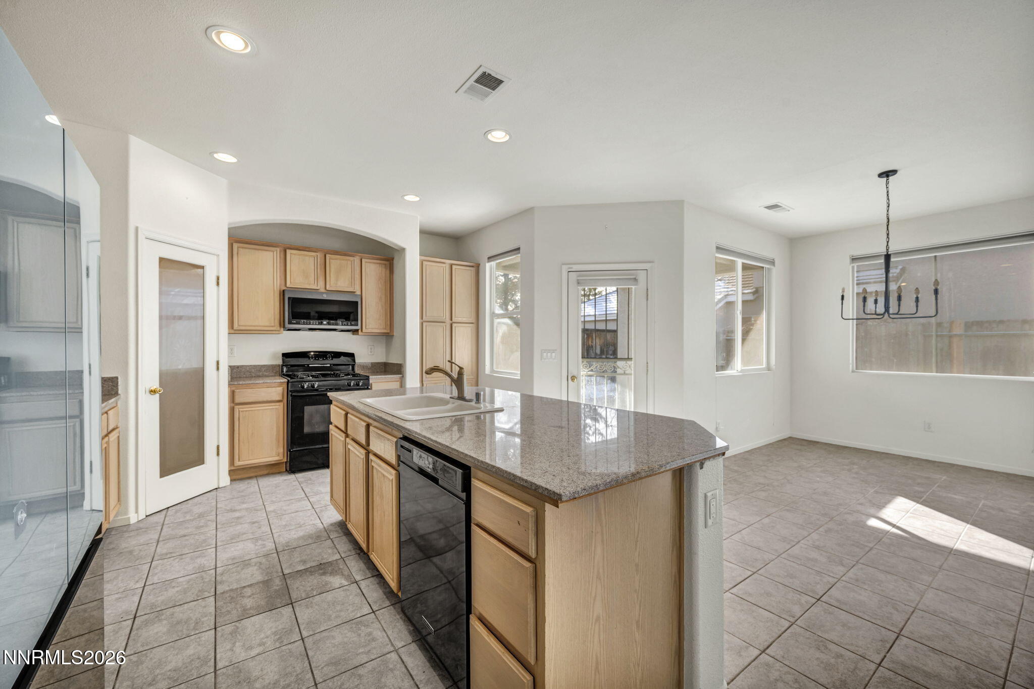 1472 Gaucho Lane Reno, NV 89521 - Photo 17 of 38 a kitchen with stainless steel appliances granite countertop a sink stove and refrigerator