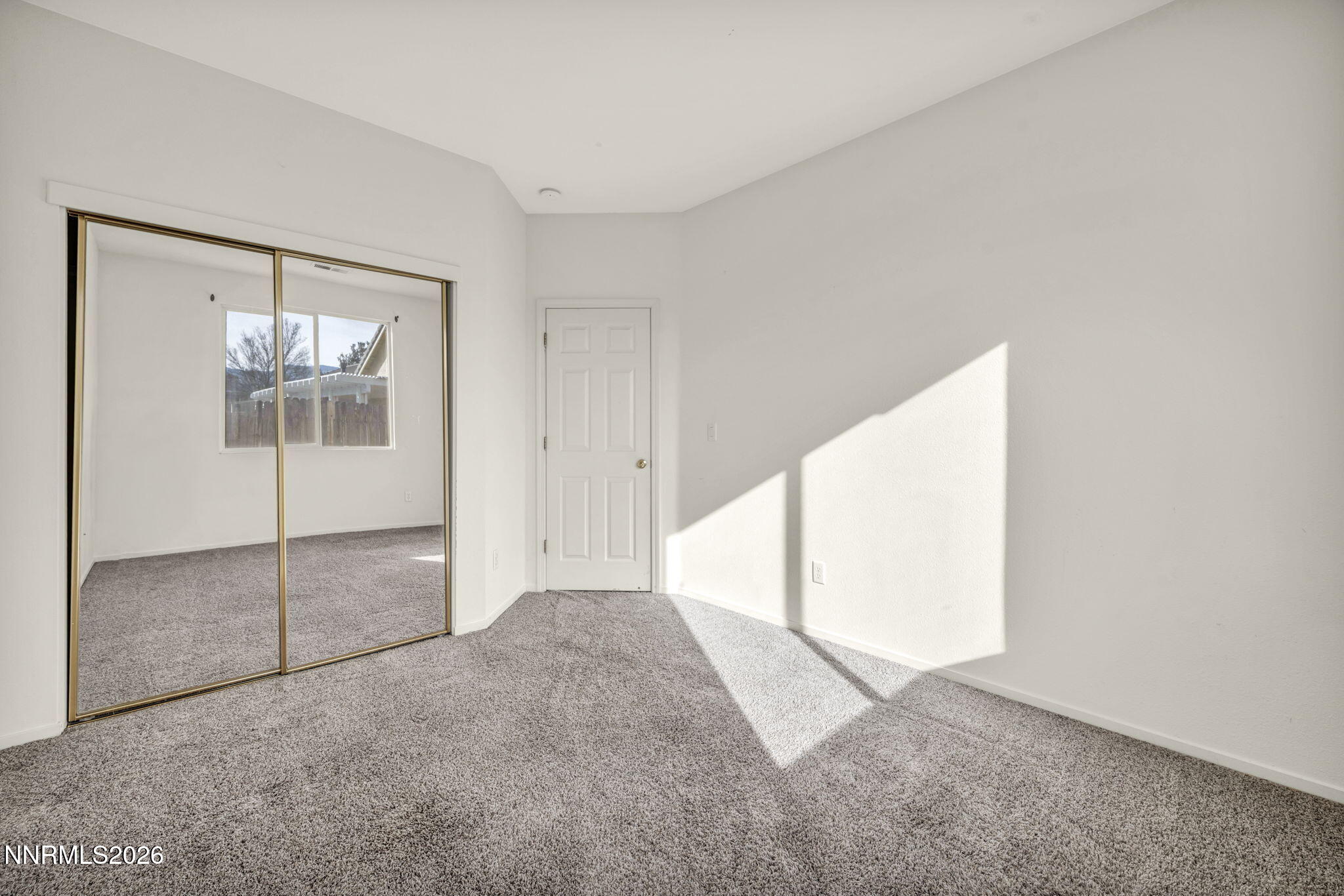 1472 Gaucho Lane Reno, NV 89521 - Photo 33 of 38 an empty room with windows and closet