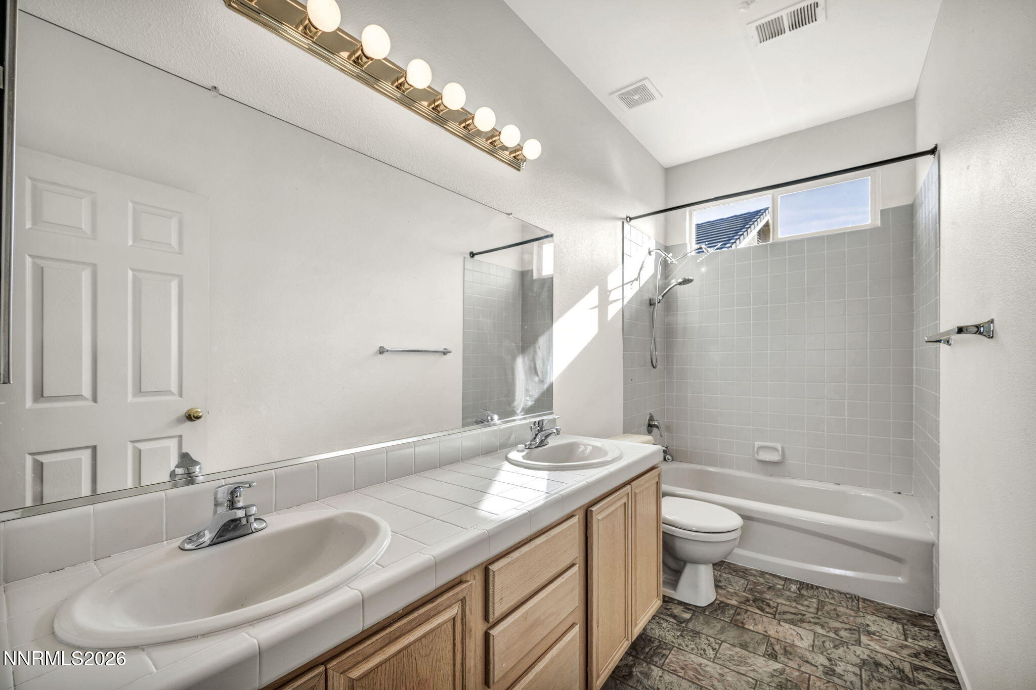 1472 Gaucho Lane Reno, NV 89521 - Photo 34 of 38 a bathroom with a granite countertop sink toilet and shower
