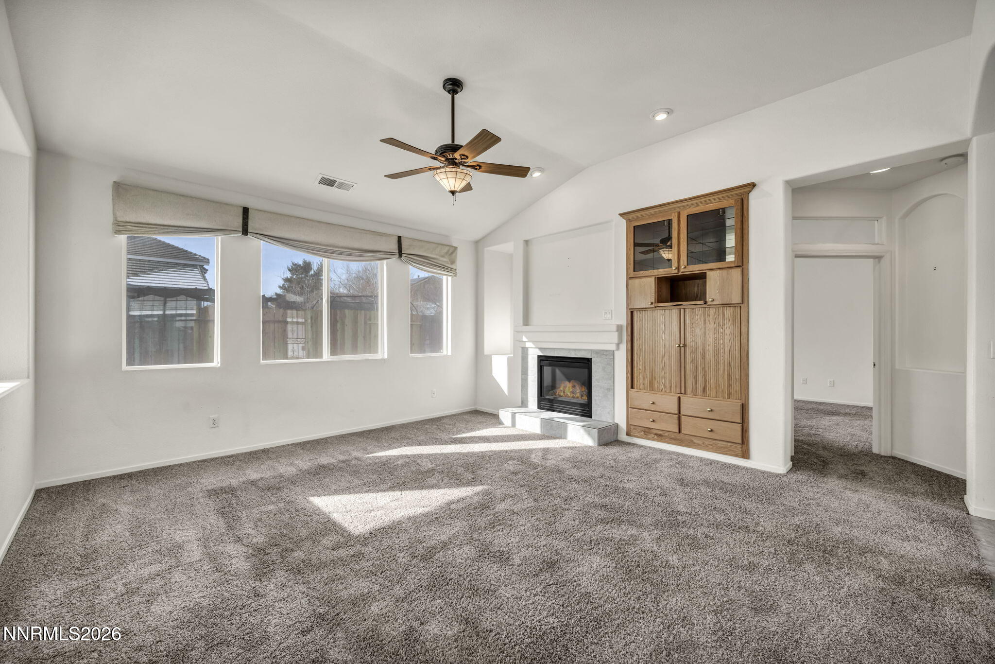 1472 Gaucho Lane Reno, NV 89521 - Photo 6 of 38 a view of an empty room with a fireplace and a window