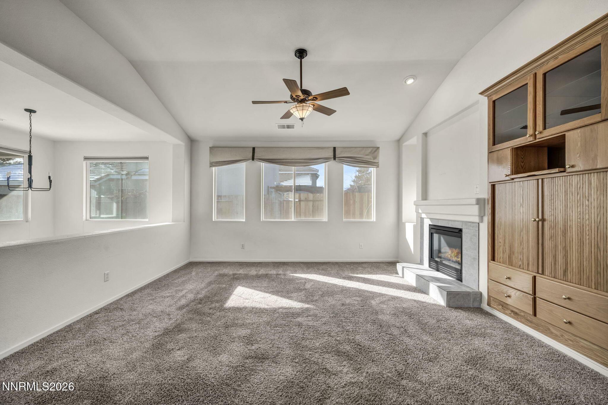 1472 Gaucho Lane Reno, NV 89521 - Photo 7 of 38 a view of a livingroom with a fireplace window and a chandelier