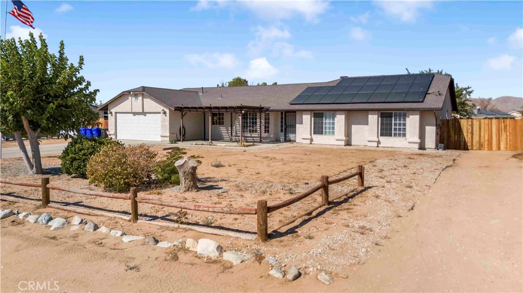 15189 Tonikan Road Apple Valley, CA 92307 - Photo 1 of 39 a front view of a house with yard and garage