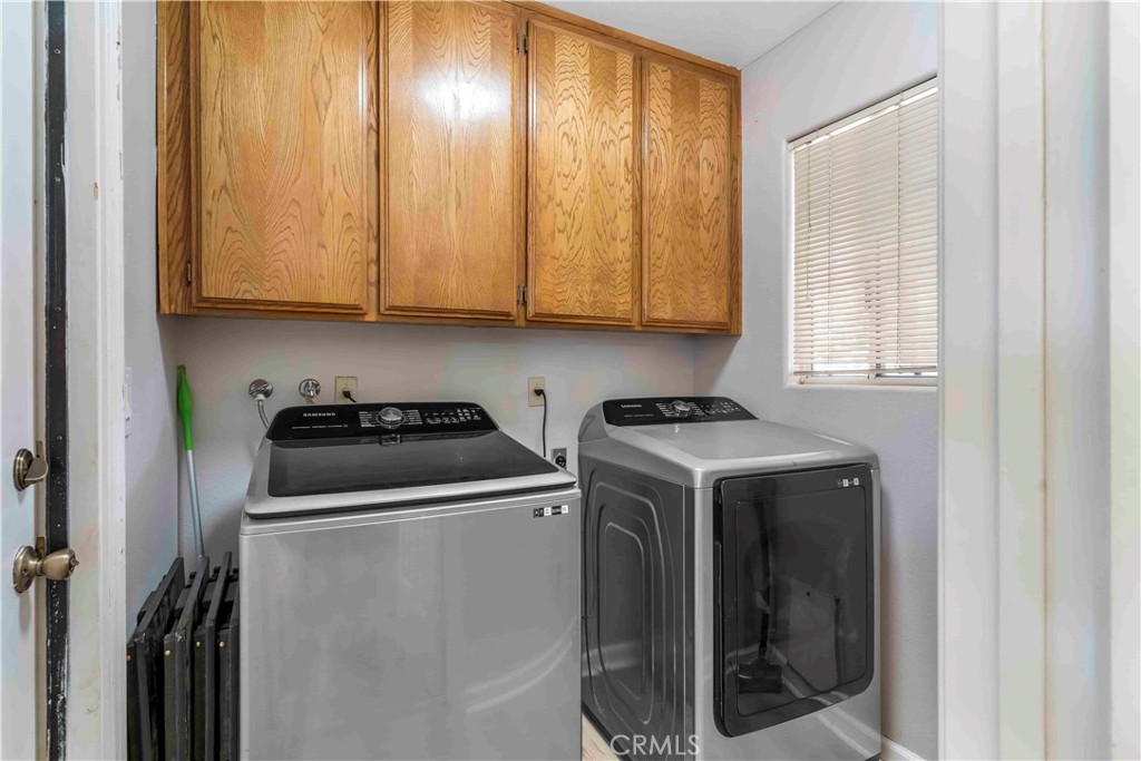 15189 Tonikan Road Apple Valley, CA 92307 - Photo 17 of 39 a view of a utility room with washer and dryer