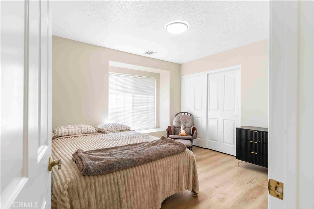 15189 Tonikan Road Apple Valley, CA 92307 - Photo 25 of 39 a bedroom with a bed and window