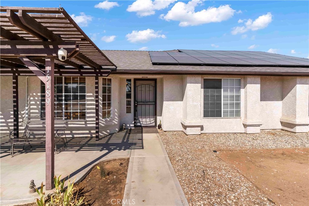 15189 Tonikan Road Apple Valley, CA 92307 - Photo 9 of 39 a front view of a house with a sitting area