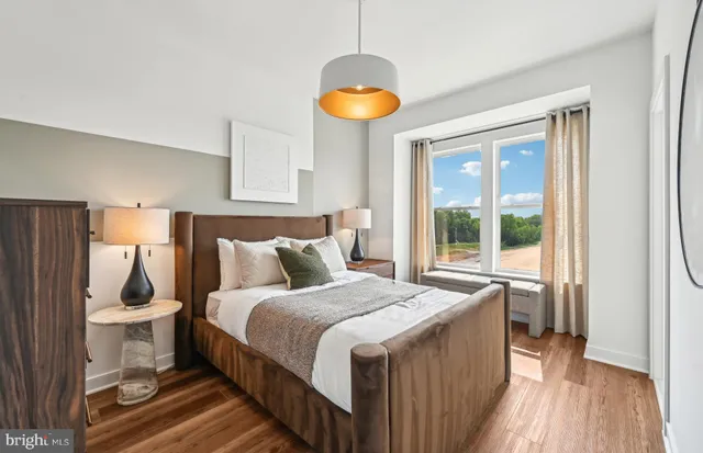 a bedroom with a bed and a lamp on table