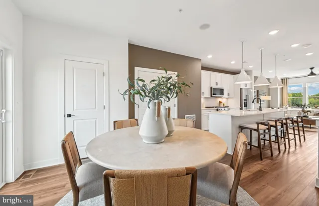 a dining room with furniture and wooden floor
