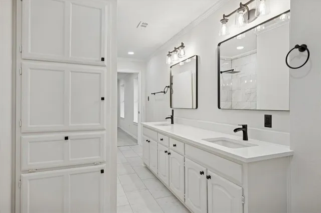 a bathroom with double vanity sink and a mirror