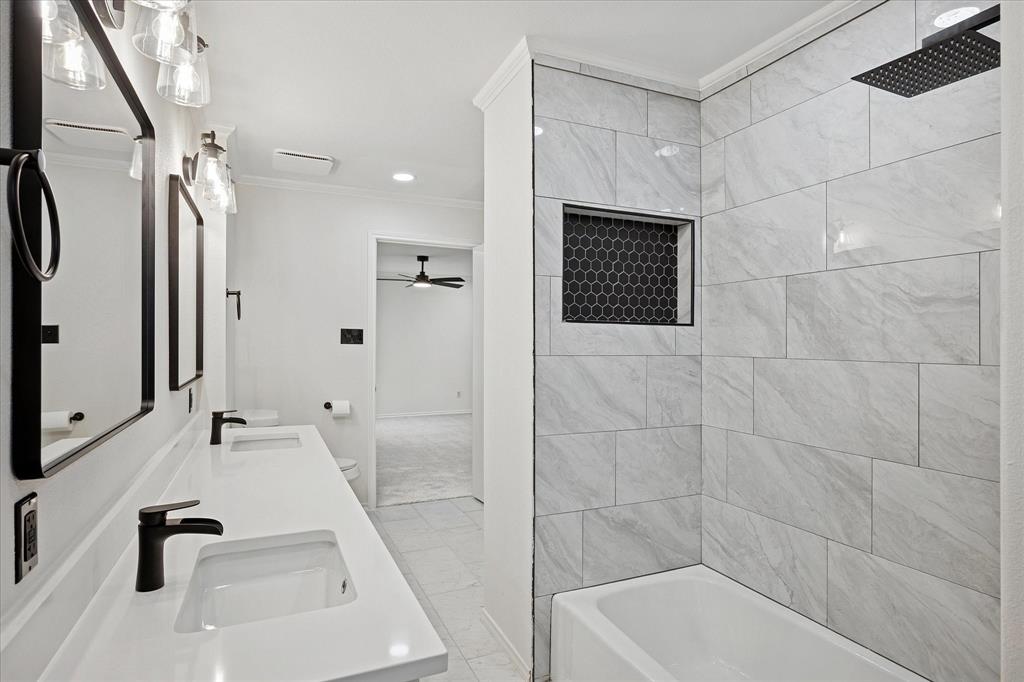 62 Legend Road Benbrook, TX 76132 - Photo 26 of 27 a bathroom with a tub a sink a window and a shower