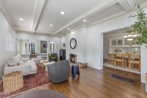 a dining room with wooden floor and a chandelier