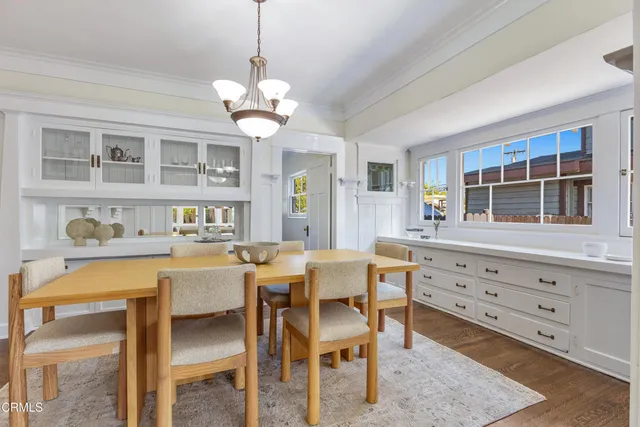 a view of a dining room with furniture wooden floor and chandelier
