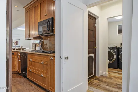 a kitchen with granite countertop wooden cabinets and stainless steel appliances