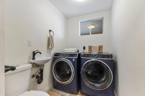 a kitchen with a sink a counter space appliances and cabinets