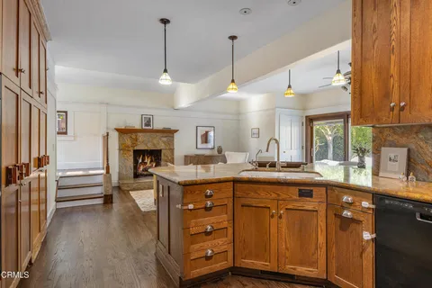 a dining room with furniture a window and kitchen view