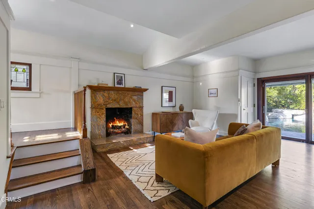 a dining room with furniture and wooden floor