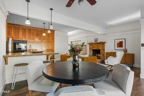 a living room with furniture a ceiling fan and a rug