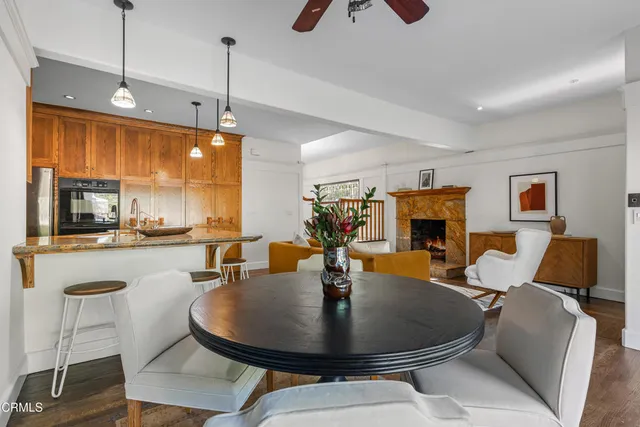 a living room with furniture a ceiling fan and a rug