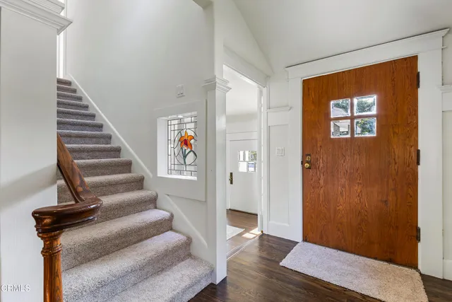 a bedroom with a large bed couch and a window