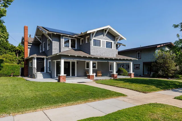 a front view of a house with a yard table and chairs