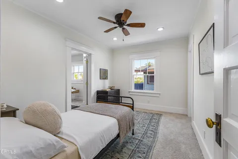 a living room with furniture a rug and a window