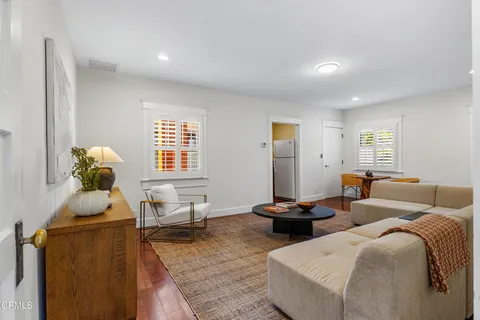 a backyard of a house with table and chairs