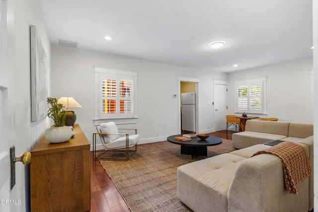 a backyard of a house with table and chairs