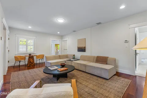 a view of a patio with a table chairs and a backyard