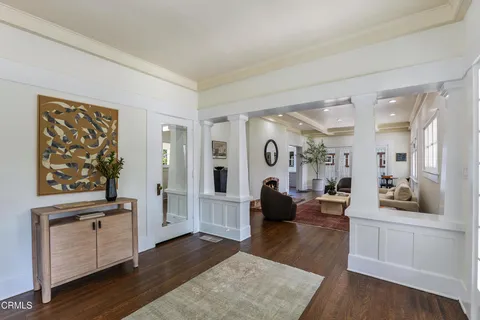 a living room with fireplace furniture and a rug