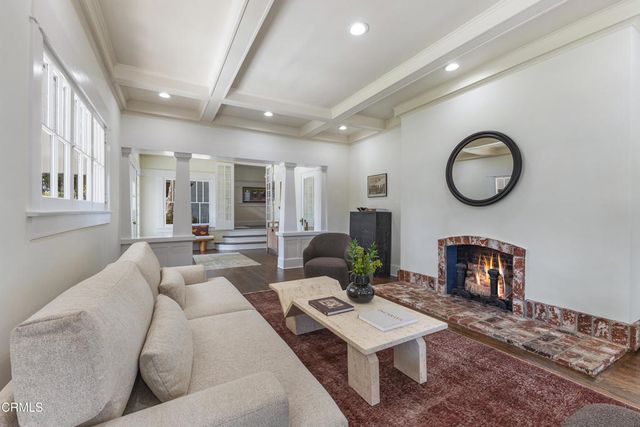 a dining room with wooden floor a glass table and chairs