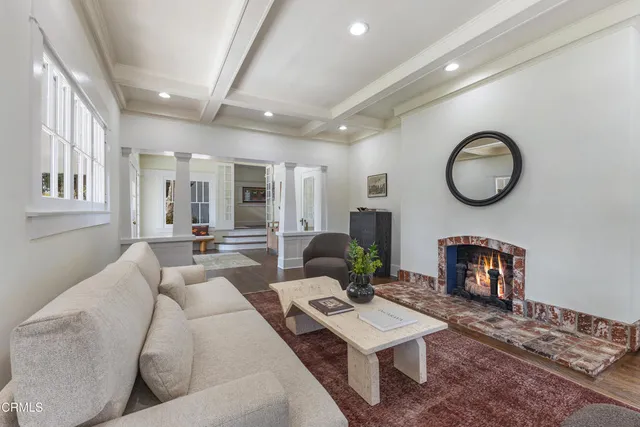 a dining room with wooden floor a glass table and chairs