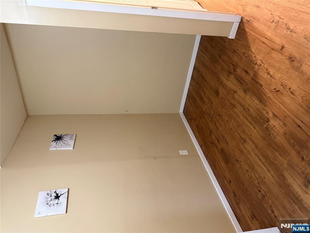 439 Cliff Street, Unit 1 Fairview, NJ 07022 - Photo 12 of 19 a view of an empty room with wooden floor and a window