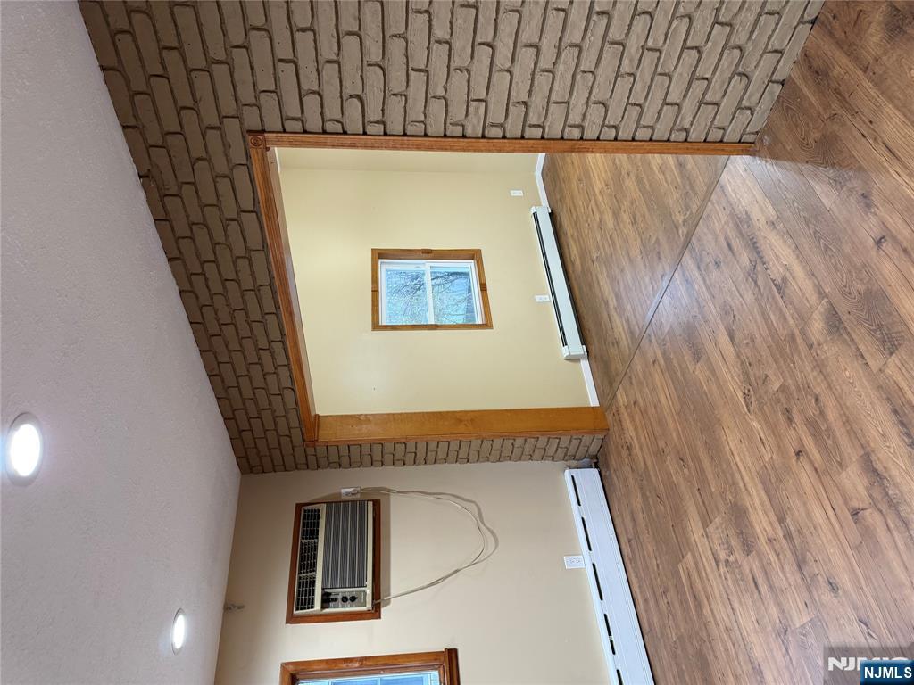 439 Cliff Street, Unit 1 Fairview, NJ 07022 - Photo 14 of 19 a view of an empty room with wooden floor and a window