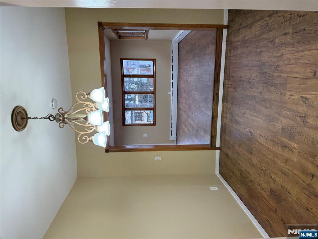 439 Cliff Street, Unit 1 Fairview, NJ 07022 - Photo 6 of 19 a view of wooden floor and chandelier in a room