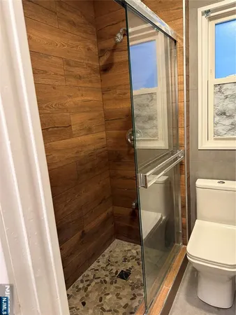 a bathroom with a toilet sitting next to a window