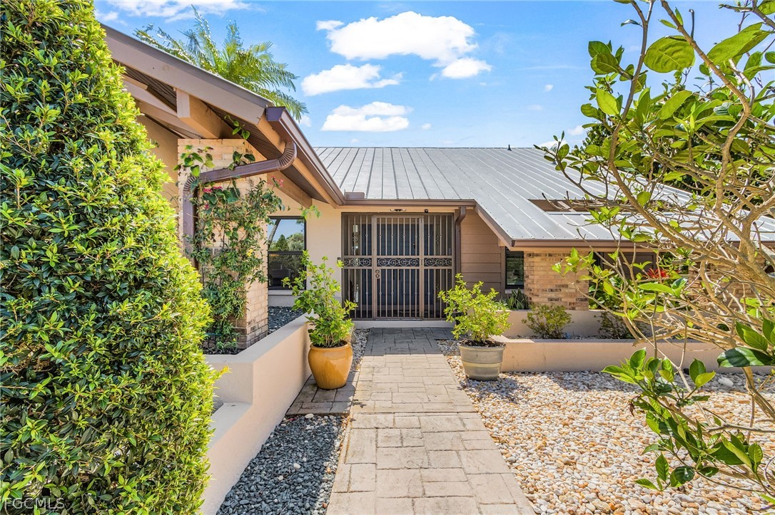 7747 Grande Pine Road Bokeelia, FL 33922 - Photo 6 of 45 a front view of a house with a garden